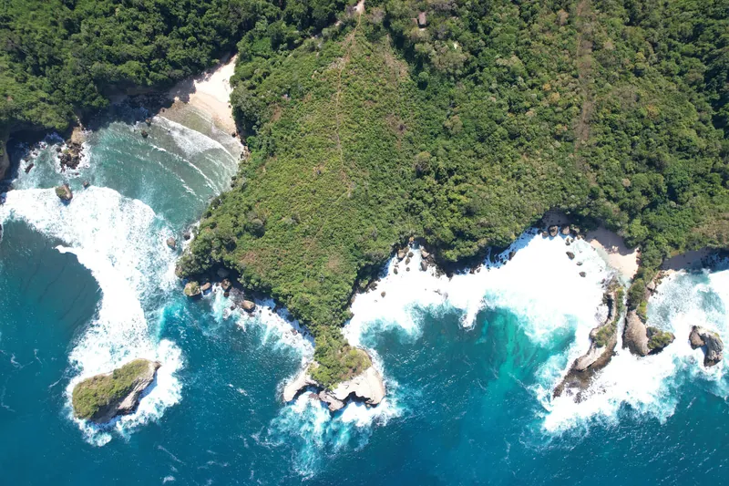Aerial shot of Kabisu cliffside land with hidden beach in Sumba
